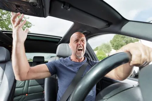 An angry man is about to get into a road rage car accident.