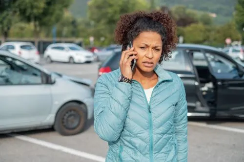 A woman calls her insurance agent after an accident in someone else's car.