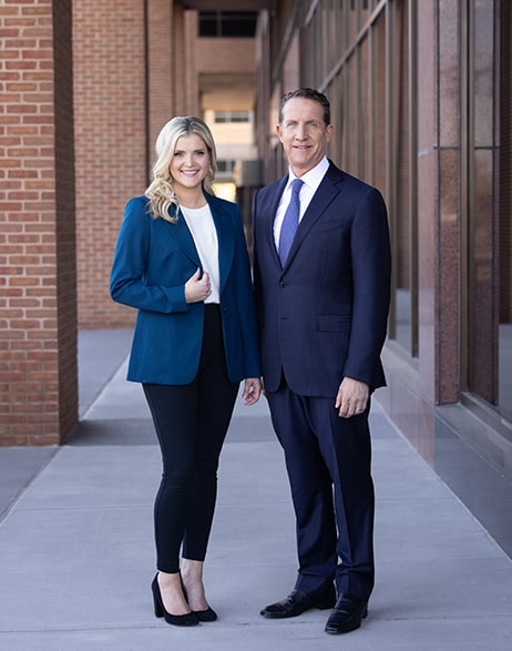 Taxi Accident Lawyers Thomas Singer & Amanda Murphy wearing dark suit jackets.